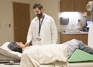 Technician preparing woman for x-ray.