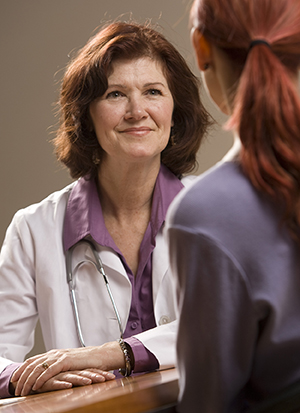 Woman talking to healthcare provider.