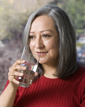 Woman drinking glass of water.