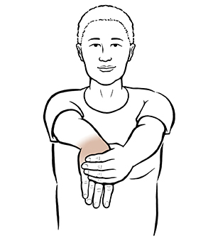 Woman doing wrist flexion exercise.