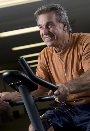 Man riding exercise bike.